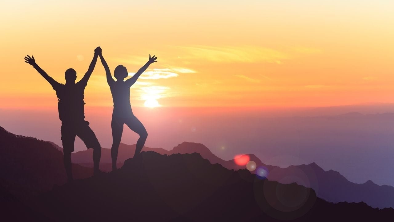 A guy and a girl standing on a mountain